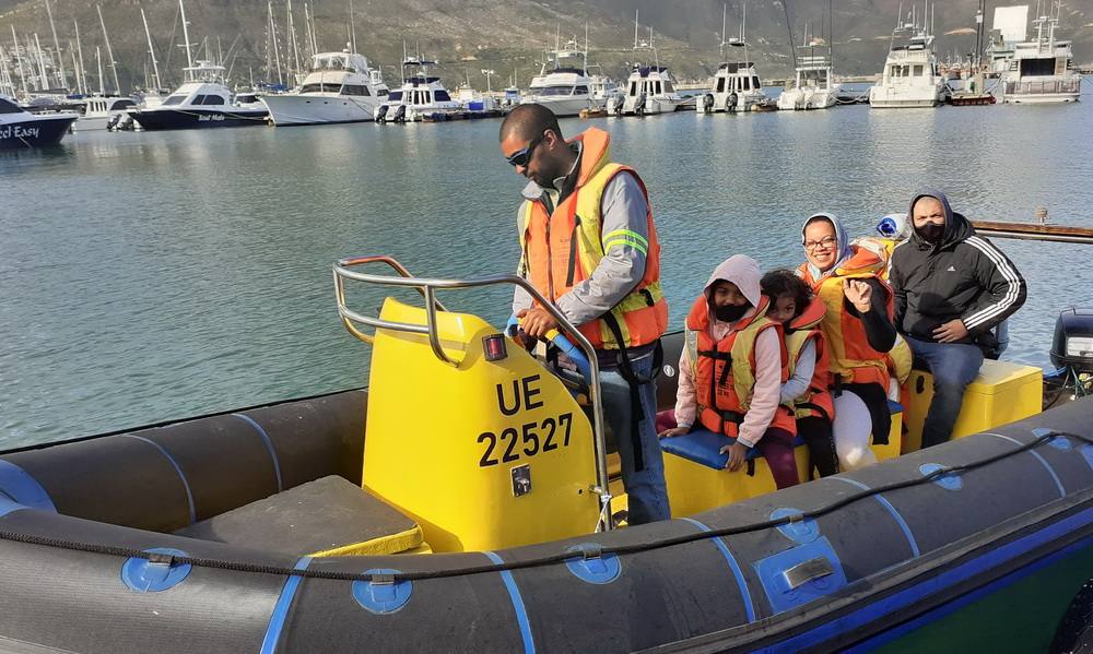 Family enjoying a leisure boat trip picnic cruise in Cape Town